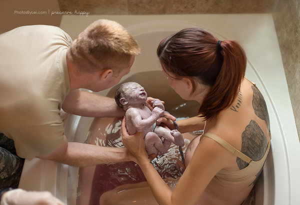 This baby was born quickly in a bathtub at home.